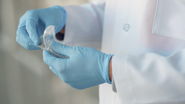 doctor preparing syringe for wound care