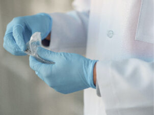 doctor preparing syringe to care for patient's wound