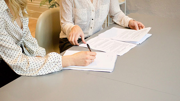 lawyer assisting a client with paperwork