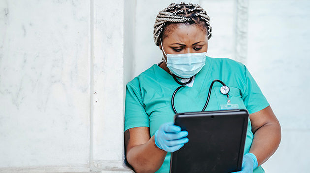 nurse examining paperwork